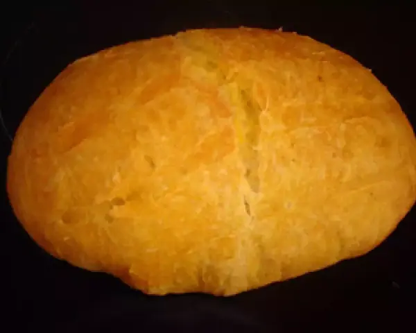 Pan de boniato dorado y esponjoso, con una corteza ligeramente agrietada, listo para disfrutar.