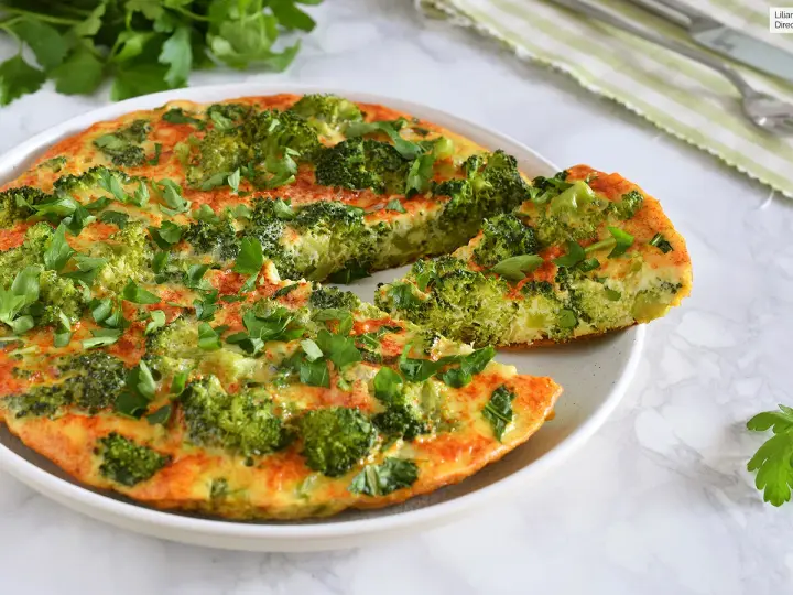 Deliciosa tortilla de brócoli, recién hecha y espolvoreada con perejil fresco. Un plato saludable y sabroso.