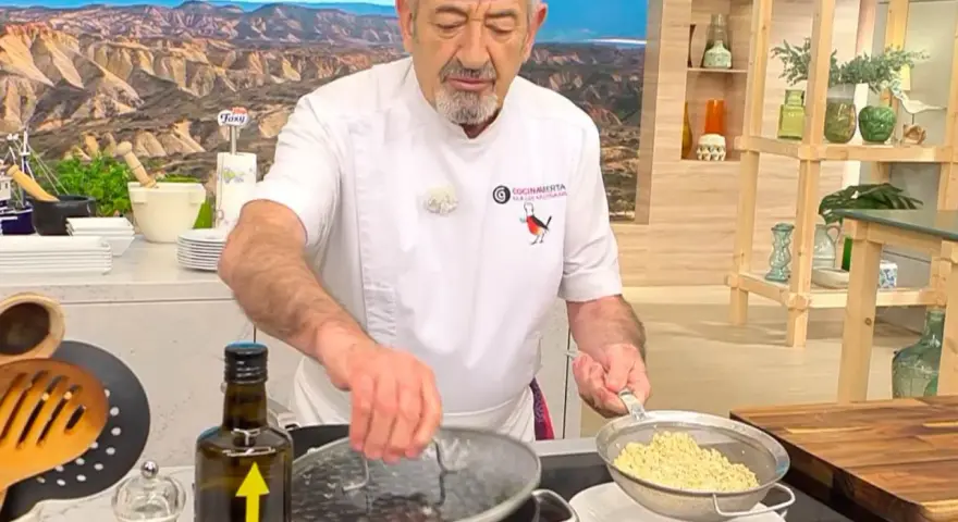 Chef muestra cómo cocinar quinoa, drenando el grano cocido en un colador.