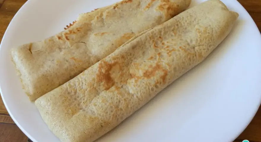 Dos crepes de avena enrollados en un plato blanco, listos para disfrutar.