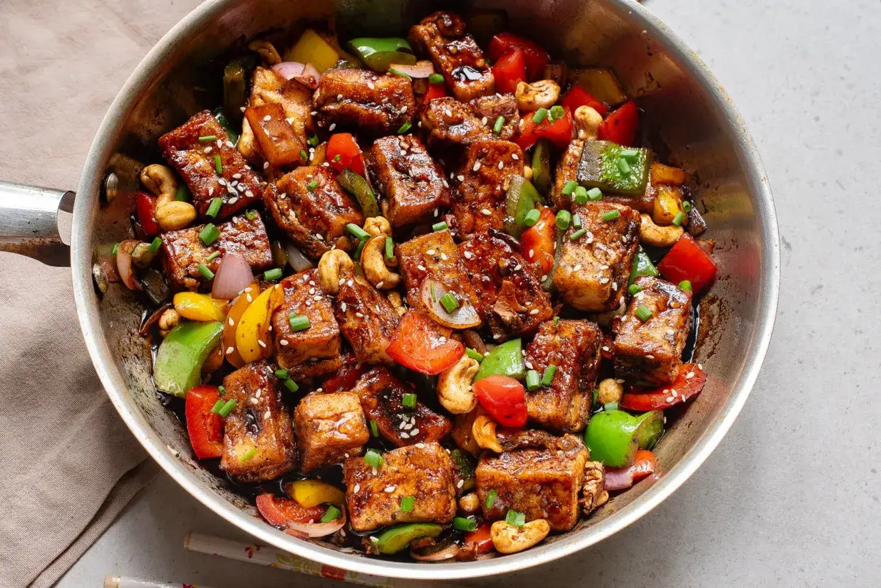 Tofu salteado con pimientos, cebolla, anacardos y semillas de s&eacute;samo. Una deliciosa forma de como cocinar tofu.